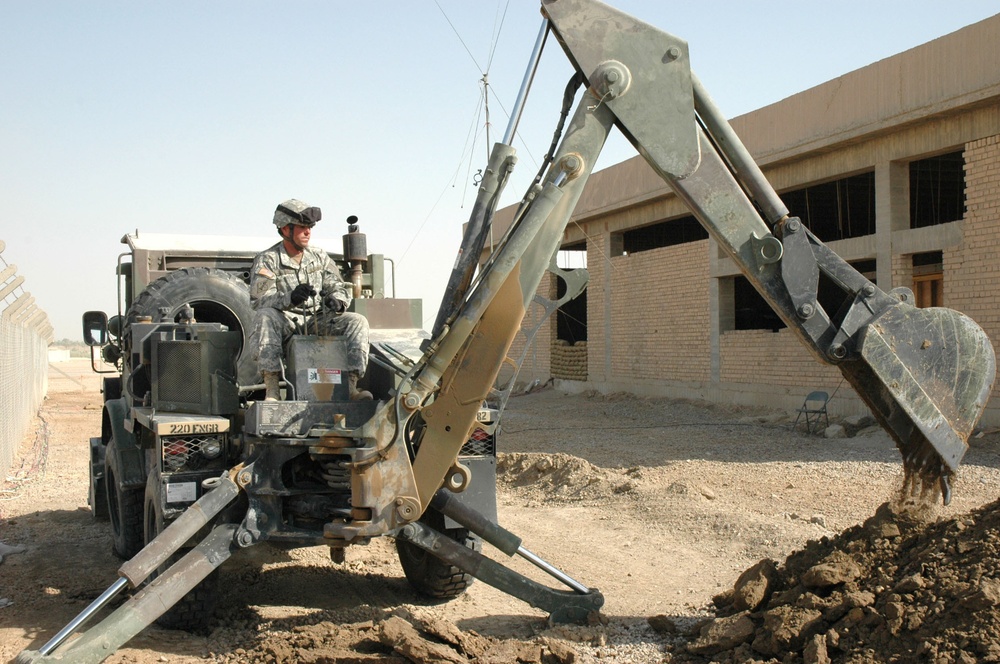 Sgt. Ray Eilerman digs a trench for fiber optic cable