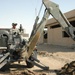 Sgt. Ray Eilerman digs a trench for fiber optic cable