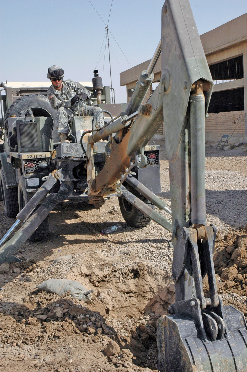 Sgt. Ray Eilerman digs a trench for fiber optic cable