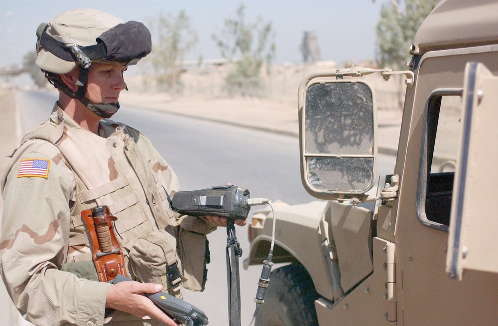 SSG Parra scans a humvees radio frequency tag with an interogat