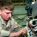 Pvt. Josh B. Dennis repairs