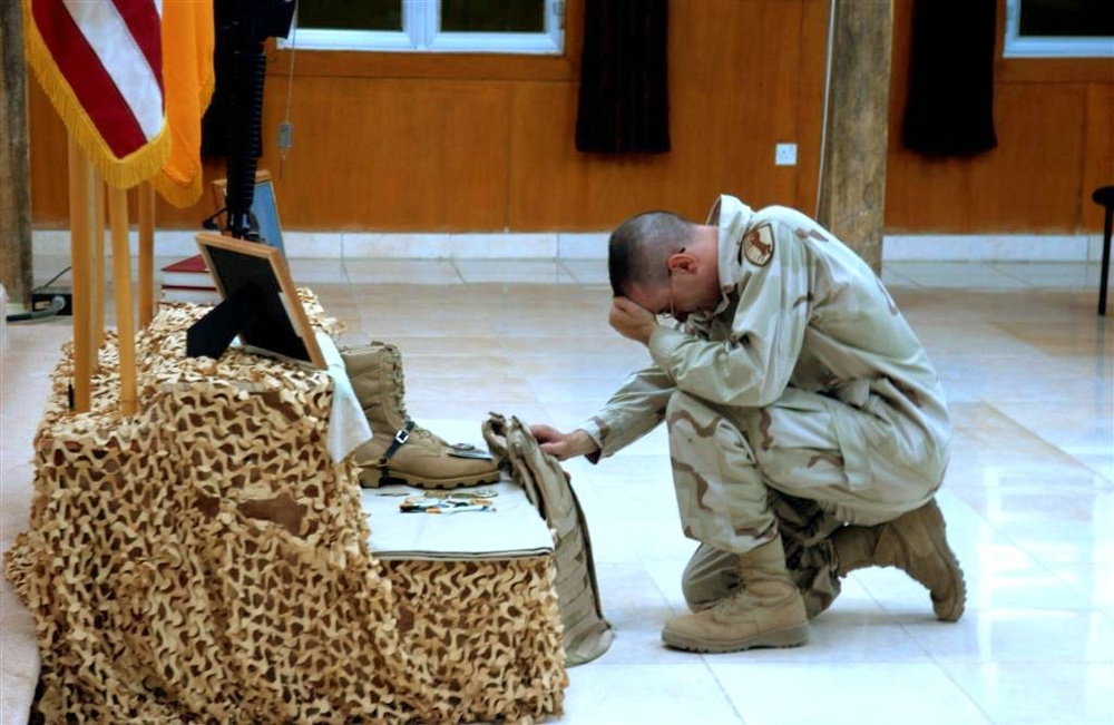 CPT Keys grieves over the loss of one of his Soldiers