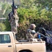 Iraqi Soldiers provide security from a side street during a cordon and sear