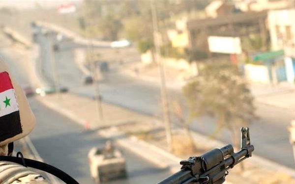 An Iraqi Soldier displays his country's flag with pride by wearing i
