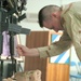 Maj. Robert Petit grips the ID tags of Chief Warrant Officer 4 Keith R. Mar