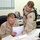 SPC Mitchell and PFC George go over supply forms in the battalion supply of