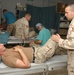 Staff Sgt. Thomas Leach, checks out the knee of Sgt. Daniel J. S