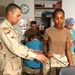 Staff Sgt. Thomas Leach, helps Sgt. Deanna Halley