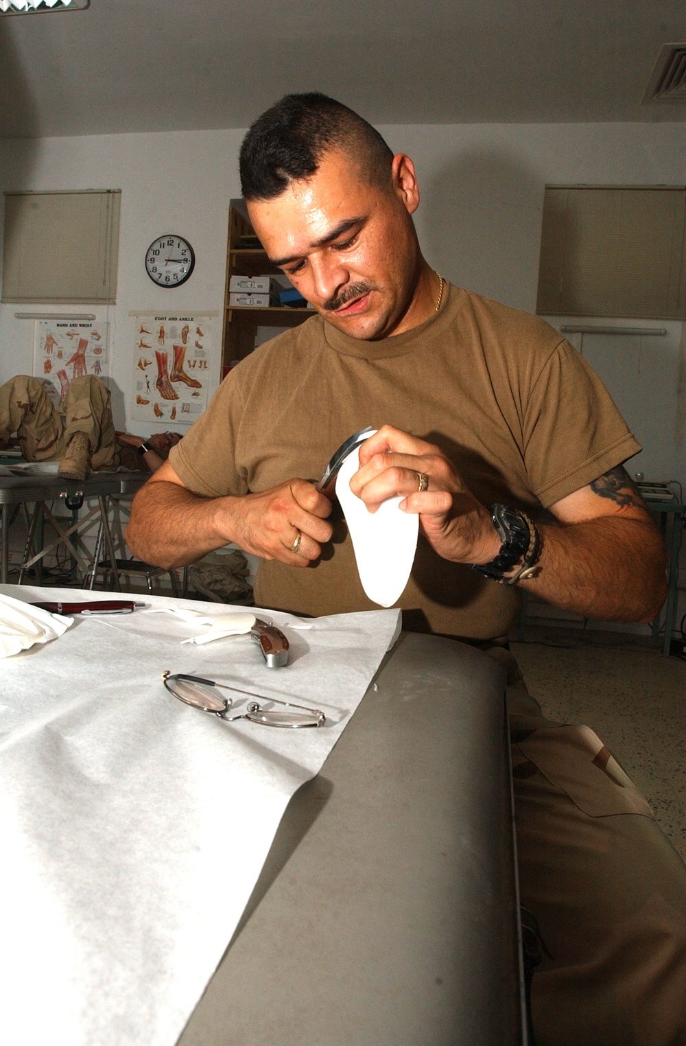 Sgt. Charles Gallego  makes a molding to go into a Soldiers boot