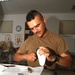 Sgt. Charles Gallego  makes a molding to go into a Soldiers boot