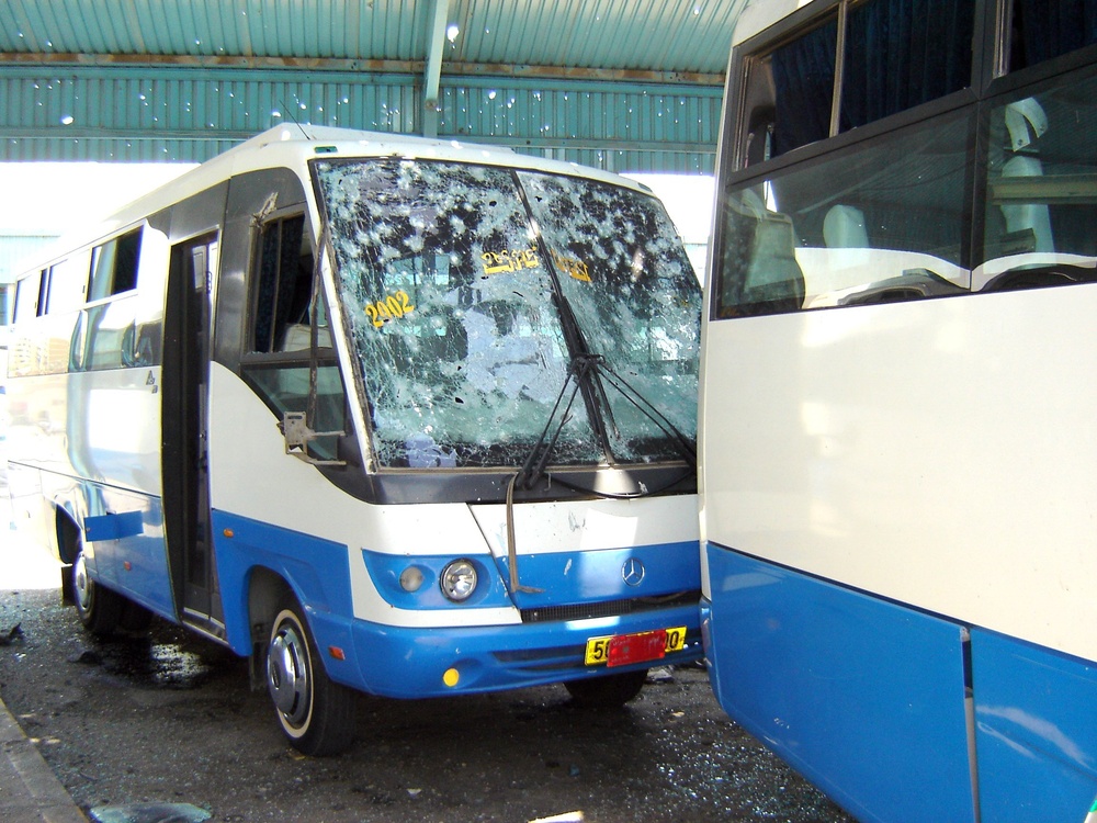 Damage resulting from a 122 millimeter rocket that struck the roof of a bus