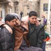 Two sons carry their wounded father