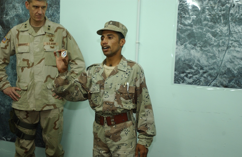 10.	An Iraqi Soldier shows off the award he was just presented with from Ma