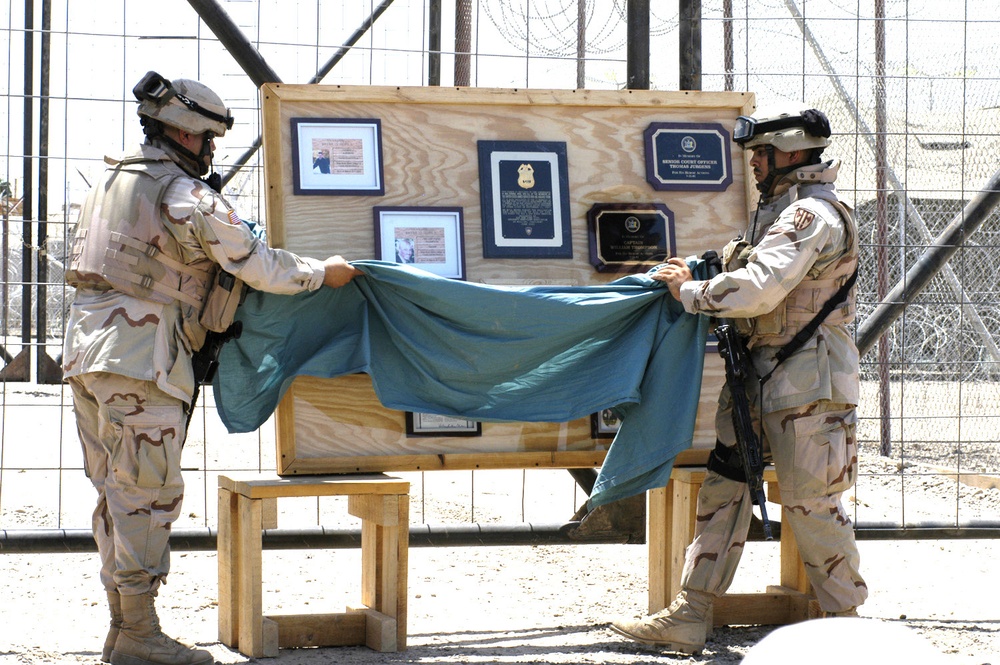 Chief Soto and SSG Mauras unveil a memorial wall at a dedication