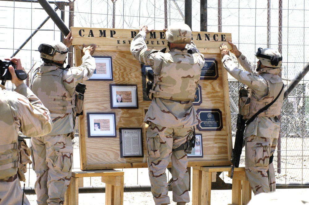 Soldiers post a sign in dedication to Camp Remembrance