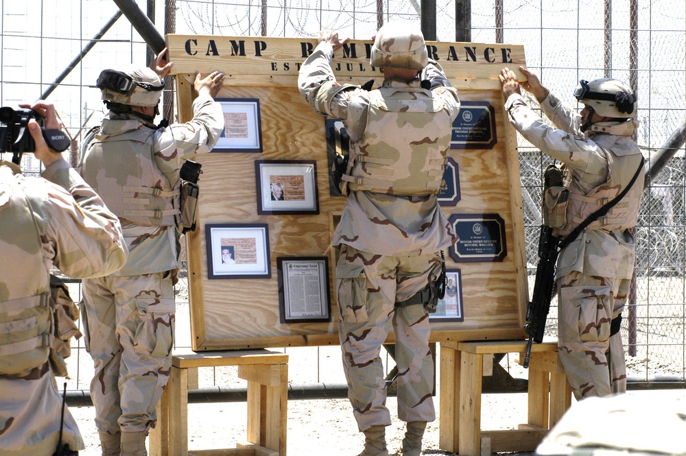 Soldiers post a sign in dedication to Camp Remembrance
