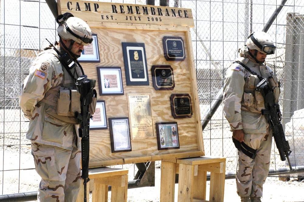 Chief Soto and SSG Mauras bow their heads in prayer