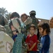 CPT Price helps a girl into a new pair of shoes