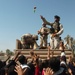 Soldiers toss stuffed animals to children
