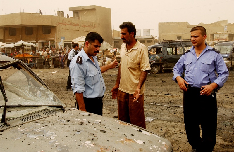 Iraqi police question an eyewitness