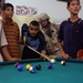 Maj. Neil Harper enjoys a game of pool with children