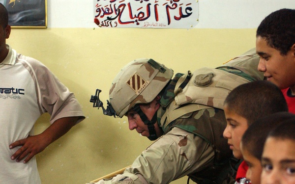 Maj. Michael Kelly challenges some Iraqi youth to a friendly gam