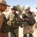 Pennsylvania National Guardsman talk to an Iraqi soldier