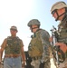 Pennsylvania National Guardsman talk to an Iraqi soldier