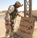 Pennsylvania National Guardsman  displays a sign warning the presence of Co