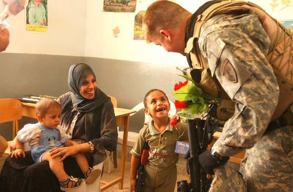 SPC Richardson speaks with a child at the Tikrit Disability Children's Organization