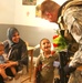 SPC Richardson speaks with a child at the Tikrit Disability Children's Organization