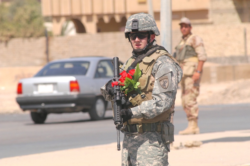 Spc. Charles Richardson watches traffic after visiting the Tikrit Disabilit