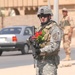 Spc. Charles Richardson watches traffic after visiting the Tikrit Disabilit