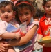 Young Iraqi girl holds baby boy