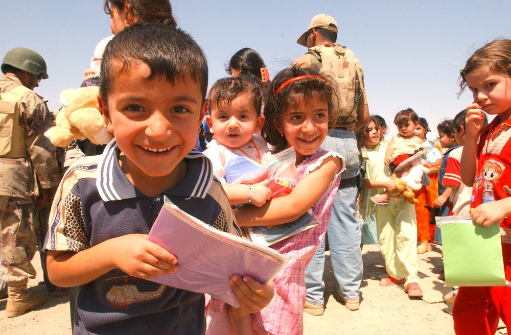 Young Iraqi boy smiles for camera