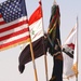 The United States Colors and the Iraqi flag fly over Forward Operating Base