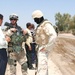 1LT Krueger and his translator talk with a local leader