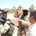 1LT Krueger and his translator talk with a local leader