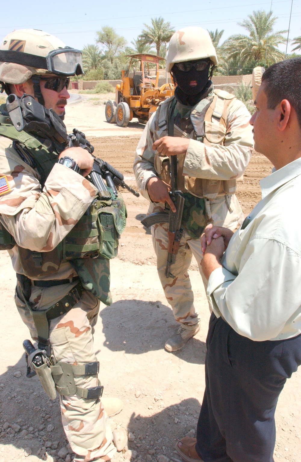 1LT Krueger and his translator talk with a local leader