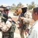1LT Krueger and his translator talk with a local leader