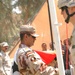 An Iraqi Soldier attaches the Iraqi Colors