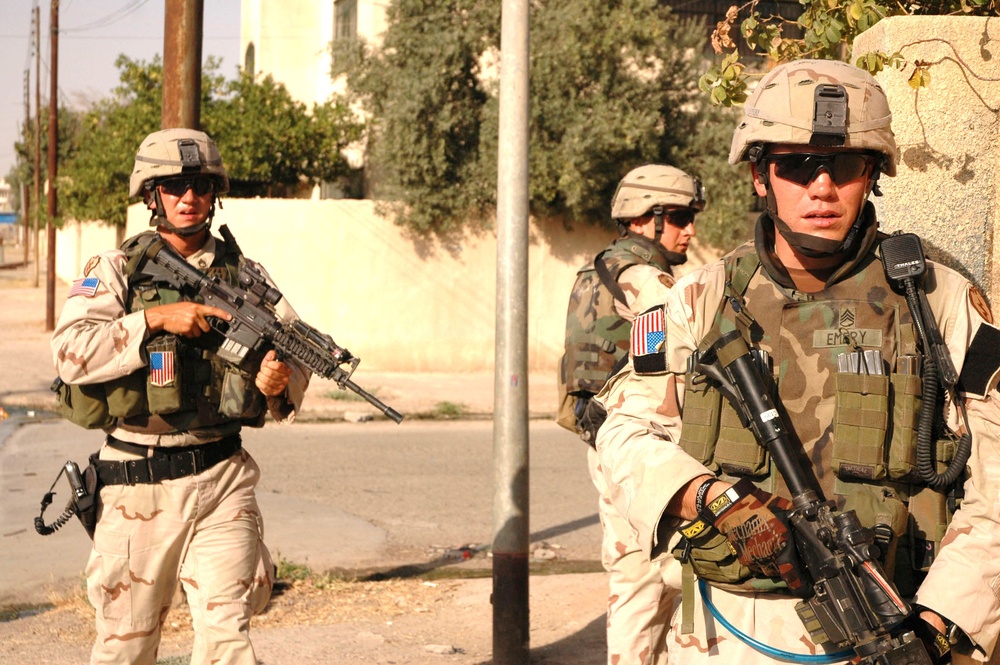 SSG Emery, SPC Henderson, and SSG Paresa conduct  foot patrol