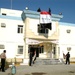 Members of the Iraqi Highway Patrol unfurl the national flag the new Iraqi