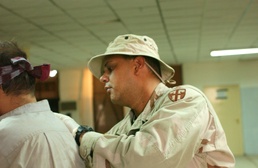 SPC Cintron searches a detainee before transporting him to a different dete