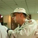 SPC Cintron searches a detainee before transporting him to a different dete