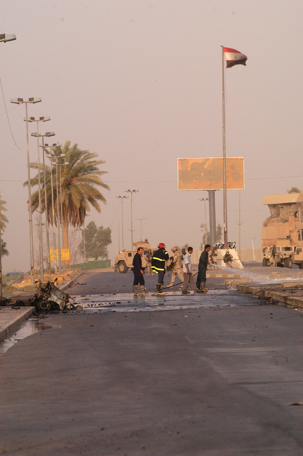 Iraqi firemen check the remnants of a detonated VBIED