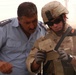 SPC Bryant uses a language guide book to communicate with a local Iraqi pol