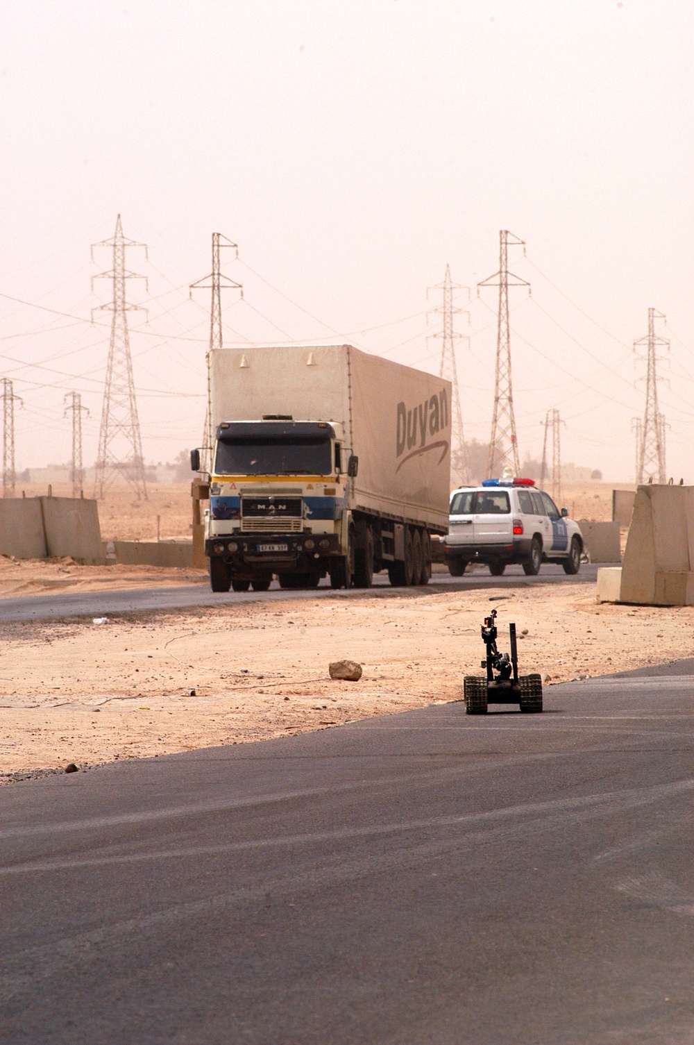 EOD uses a Talon EOD robot to check a vehicle for explosives