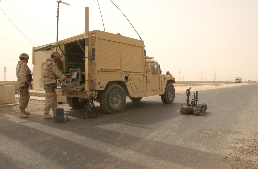 EOD uses a Talon EOD robot to check a vehicle for explosives