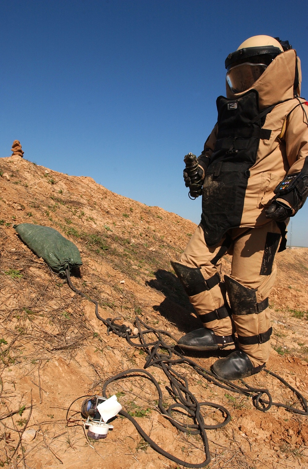 SSG Wills recovers a Motorola radio after disarming an improvised explosive